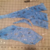 The foil/paper is now cut until it lays flat. Note that registration marks were made before cutting flat.