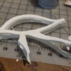 Resin castings. Note these castings are curved. Urethane resins are soft when pulled too early, so I cast them flat, pulled them before fully cured, and placed them on the mask to get a form-fitting curve